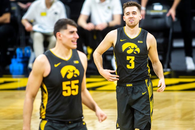 Iowa guard Jordan Bohannon (3) smiles while lining up with Iowa center Luka Garza (55) before the tip off during a NCAA Big Ten Conference men's basketball game against Wisconsin, Sunday, March 7, 2021, at Carver-Hawkeye Arena in Iowa City, Iowa.