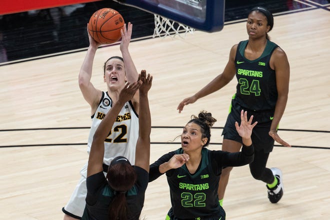 Mar 12, 2021; Indianapolis, IN, USA; Iowa Hawkeyes guard Caitlin Clark (22) shoots the ball while Michigan State Spartans guard Moira Joiner (22) defends  in the third quarter at Bankers Life Fieldhouse. Mandatory Credit: Trevor Ruszkowski-USA TODAY Sports