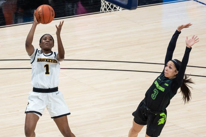 Mar 12, 2021; Indianapolis, IN, USA;  Iowa Hawkeyes guard Tomi Taiwo (1) shoots the ball while Michigan State Spartans guard Alyza Winston (3) defends in the third quarter at Bankers Life Fieldhouse. Mandatory Credit: Trevor Ruszkowski-USA TODAY Sports