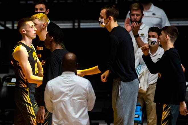 Iowa's Joe Wieskamp, left, is greeted by teammates Jack Nunge and Austin Ash during introductions before a NCAA Big Ten Conference men's basketball game against Wisconsin, Sunday, March 7, 2021, at Carver-Hawkeye Arena in Iowa City, Iowa.