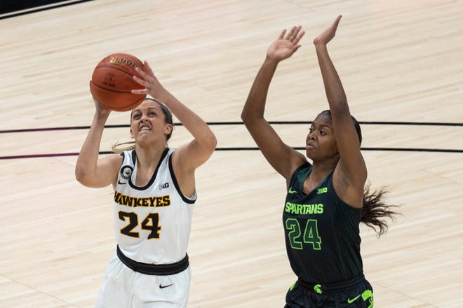 Mar 12, 2021; Indianapolis, Indiana, USA; Iowa Hawkeyes guard Gabbie Marshall (24) shoots the ball while Michigan State Spartans guard Nia Clouden (24) defends in the third quarter at Bankers Life Fieldhouse. Mandatory Credit: Trevor Ruszkowski-USA TODAY Sports