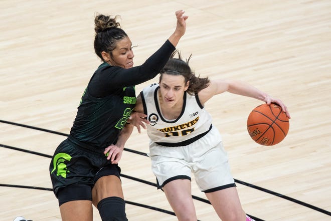 Mar 12, 2021; Indianapolis, IN, USA; Iowa Hawkeyes guard Caitlin Clark (22) dribbles the ball while Michigan State Spartans guard Moira Joiner (22) defends  in the third quarter at Bankers Life Fieldhouse. Mandatory Credit: Trevor Ruszkowski-USA TODAY Sports