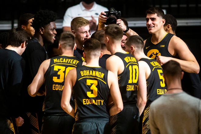 Iowa center Luka Garza, top right, huddles up with teammates before a NCAA Big Ten Conference men's basketball game against Wisconsin, Sunday, March 7, 2021, at Carver-Hawkeye Arena in Iowa City, Iowa.