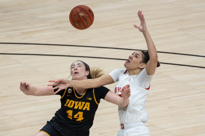 Mar 13, 2021; Indianapolis, IN, USA;  Iowa Hawkeyes guard McKenna Warnock (14) and Maryland Terrapins forward Mimi Collins (2) fight for a rebound in the first quarter at Bankers Life Fieldhouse. Mandatory Credit: Trevor Ruszkowski-USA TODAY Sports