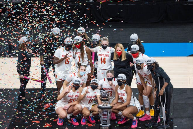 Mar 13, 2021; Indianapolis, IN, USA; The Maryland Terrapins pose with the Big Ten Championship trophy after the game against the Iowa Hawkeyes at Bankers Life Fieldhouse. Mandatory Credit: Trevor Ruszkowski-USA TODAY Sports