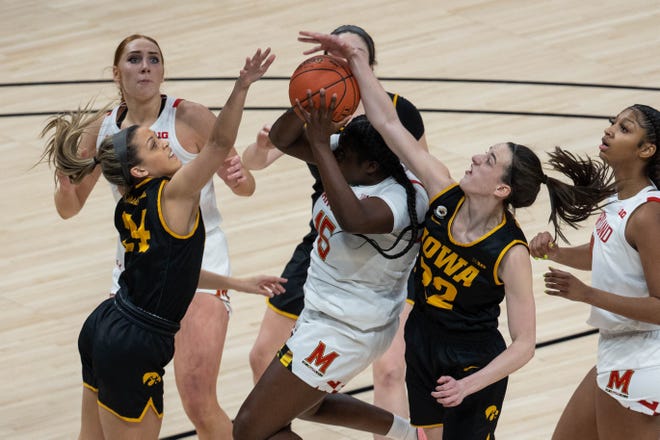 Mar 13, 2021; Indianapolis, IN, USA;  Maryland Terrapins guard Ashley Owusu (15) shoots the ball while Iowa Hawkeyes guard Caitlin Clark (22) defends in the first quarter at Bankers Life Fieldhouse. Mandatory Credit: Trevor Ruszkowski-USA TODAY Sports