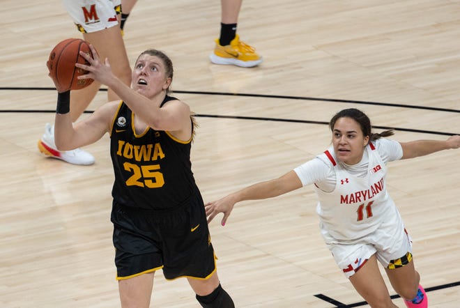 Mar 13, 2021; Indianapolis, IN, USA; Iowa Hawkeyes forward Monika Czinano (25) shoots the ball while Maryland Terrapins guard Katie Benzan (11) defends  in the fourth quarter at Bankers Life Fieldhouse. Mandatory Credit: Trevor Ruszkowski-USA TODAY Sports