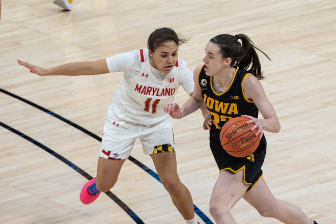 Mar 13, 2021; Indianapolis, IN, USA;  Iowa Hawkeyes guard Caitlin Clark (22) dribbles the ball whileMaryland Terrapins guard Katie Benzan (11) defends in the third quarter at Bankers Life Fieldhouse. Mandatory Credit: Trevor Ruszkowski-USA TODAY Sports