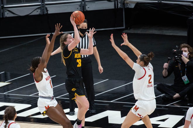 Mar 13, 2021; Indianapolis, IN, USA; Iowa Hawkeyes guard Kate Martin (20) shoots the ball while Maryland Terrapins forward Mimi Collins (2) defends  in the second quarter at Bankers Life Fieldhouse. Mandatory Credit: Trevor Ruszkowski-USA TODAY Sports