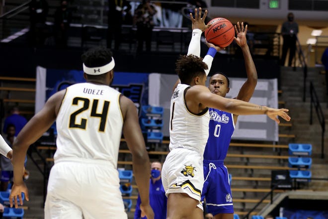WEST LAFAYETTE, INDIANA - MARCH 18: D.J. Wilkins #0 of the Drake Bulldogs shoots the ball against Tyson Etienne #1 of the Wichita State Shockers during the first half in the First Four game prior to the NCAA Men's Basketball Tournament at Mackey Arena on March 18, 2021 in West Lafayette, Indiana.
