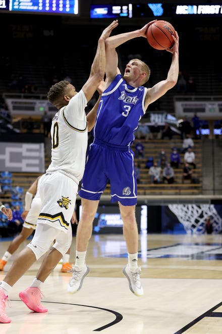 WEST LAFAYETTE, INDIANA - MARCH 18: Garrett Sturtz #3 of the Drake Bulldogs attempts to shoot over Dexter Dennis #0 of the Wichita State Shockers during the first half in the First Four game prior to the NCAA Men's Basketball Tournament at Mackey Arena on March 18, 2021 in West Lafayette, Indiana.