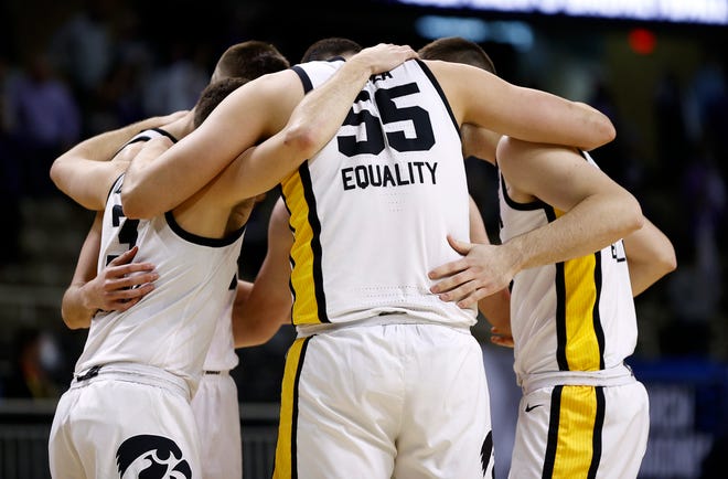 INDIANAPOLIS, INDIANA - MARCH 20: Luka Garza #55 of the Iowa Hawkeyes huddles with his team on the court during the first half against the Grand Canyon Antelopes in the first round game of the 2021 NCAA Men's Basketball Tournament at Indiana Farmers Coliseum on March 20, 2021 in Indianapolis, Indiana.