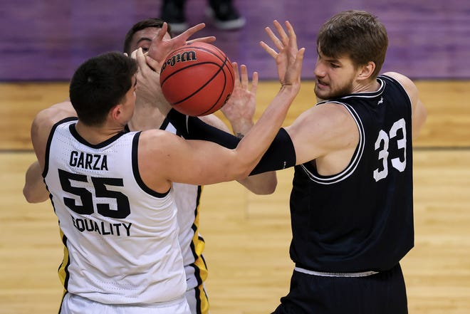 Mar 20, 2021; Indianapolis, IN, USA; Iowa Hawkeyes center Luka Garza (55) and Grand Canyon Antelopes center Asbj¿rn Midtgaard (33) fight for the ball during the first round of the 2021 NCAA Tournament at Indiana Farmers Coliseum.  Mandatory Credit: Aaron Doster-USA TODAY Sports