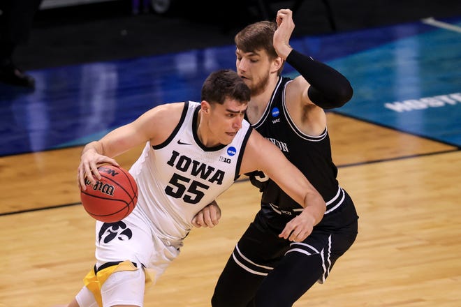 Mar 20, 2021; Indianapolis, IN, USA; Iowa Hawkeyes center Luka Garza (55) brings the ball up court against Grand Canyon Antelopes center Asbj¿rn Midtgaard (33) during the first round of the 2021 NCAA Tournament at Indiana Farmers Coliseum.  Mandatory Credit: Aaron Doster-USA TODAY Sports