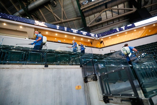 Cleaning crews prepare the stadium for fans before the USC vs. Drake game during the first round of the 2021 NCAA Tournament on Saturday, March 20, 2021, at Bankers Life Fieldhouse in Indianapolis, Ind.