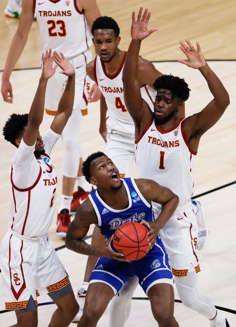 Drake forward ShanQuan Hemphill (4) attempts to shoot the ball as USC guard Tahj Eaddy (2) and forward Chavez Goodwin (1) defend during the first round of the 2021 NCAA Tournament on Saturday, March 20, 2021, at Bankers Life Fieldhouse in Indianapolis, Ind.