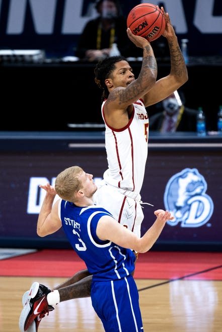 USC guard Isaiah White (5) hits a shot and draws a foul from Drake guard Garrett Sturtz (3) during the first round of the 2021 NCAA Tournament on Saturday, March 20, 2021, at Bankers Life Fieldhouse in Indianapolis, Ind.