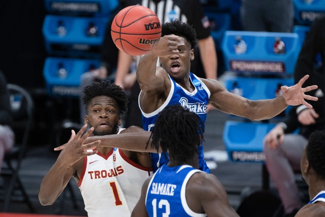Drake guard Joseph Yesufu (1) knocks the ball away from USC forward Chavez Goodwin (1) during the first round of the 2021 NCAA Tournament on Saturday, March 20, 2021, at Bankers Life Fieldhouse in Indianapolis, Ind.