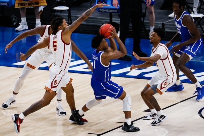 Drake guard Joseph Yesufu (1) attempts to push past USC guard Tahj Eaddy (2) during the first round of the 2021 NCAA Tournament on Saturday, March 20, 2021, at Bankers Life Fieldhouse in Indianapolis, Ind.