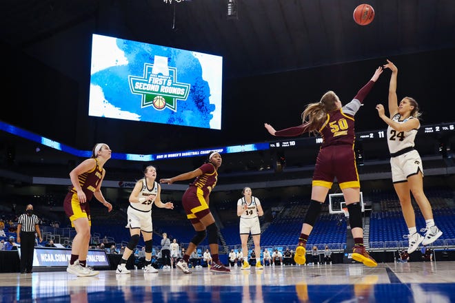 SAN ANTONIO, TEXAS - MARCH 21: Gabbie Marshall #24 of the Iowa Hawkeyes puts up a shot over Kyra Bussell #50 of the Central Michigan Chippewas during the first half in the first round game of the 2021 NCAA Women's Basketball Tournament at the Alamodome on March 21, 2021 in San Antonio, Texas.