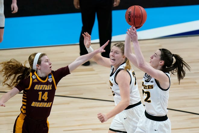 Iowa guard Caitlin Clark, right, shoots over Central Michigan guard Molly Davis (14) during the second half of a college basketball game in the first round of the women's NCAA tournament at the Alamodome, Sunday, March 21, 2021, in San Antonio.