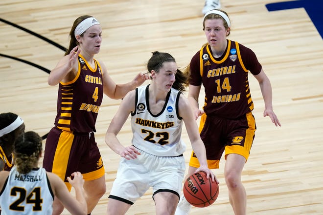 Iowa guard Caitlin Clark (22) drives ahead of Central Michigan guard Maddy Watters (4) and guard Molly Davis (14) during the second half of a college basketball game in the first round of the women's NCAA tournament at the Alamodome, Sunday, March 21, 2021, in San Antonio.