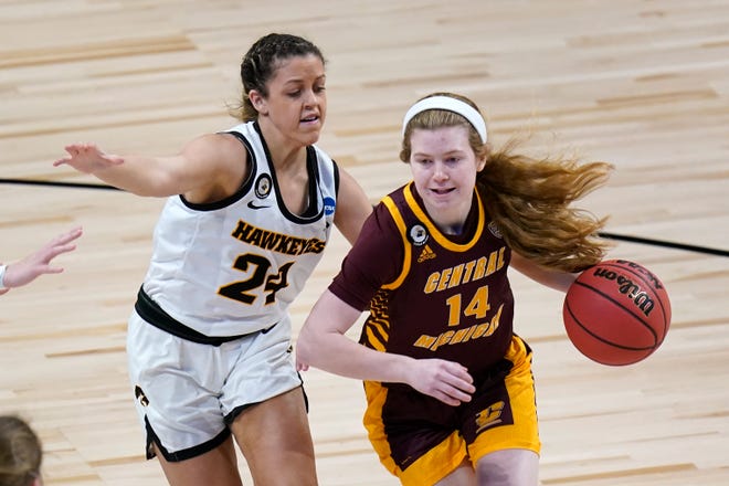 Central Michigan guard Molly Davis (14) drives past Iowa guard Gabbie Marshall (24) during the first half of a college basketball game in the first round of the women's NCAA tournament at the Alamodome, Sunday, March 21, 2021, in San Antonio.