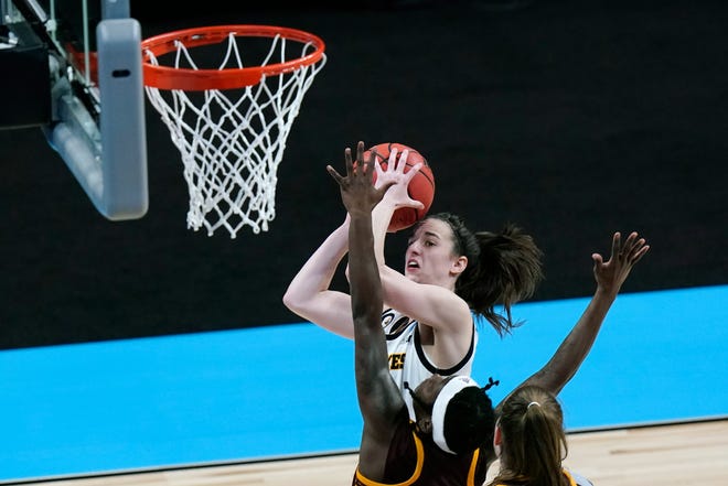 Iowa guard Caitlin Clark, top, shoots over Central Michigan guard Micaela Kelly during the second half of a college basketball game in the first round of the women's NCAA tournament at the Alamodome, Sunday, March 21, 2021, in San Antonio.
