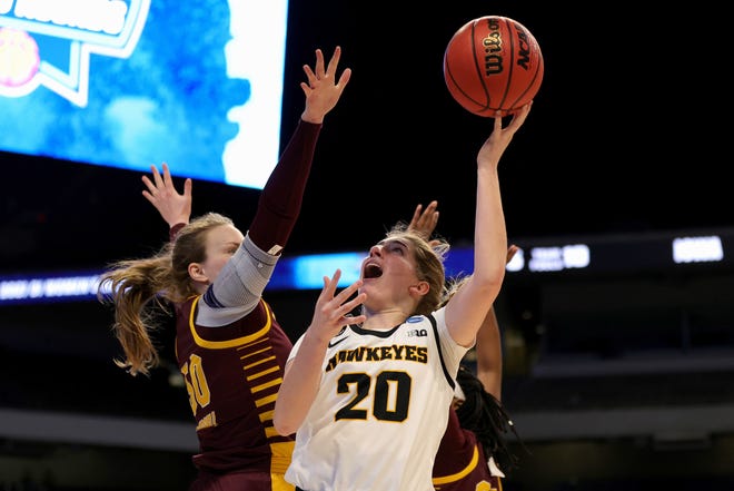 SAN ANTONIO, TEXAS - MARCH 21: Kate Martin #20 of the Iowa Hawkeyes drives to the basket ahead of Kyra Bussell #50 of the Central Michigan Chippewas during the first half in the first round game of the 2021 NCAA Women's Basketball Tournament at the Alamodome on March 21, 2021 in San Antonio, Texas. (Photo by Carmen Mandato/Getty Images)