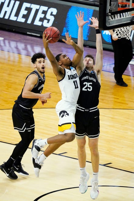 March 20, 2021; Indianapolis, IN, USA; Iowa Hawkeyes guard Tony Perkins (11) scores against Grand Canyon Antelopes center Alessandro Lever (25) in the first half during the first round of the 2021 NCAA Tournament on Saturday, March 20, 2021, at Indiana Farmers Coliseum in Indianapolis, Ind.