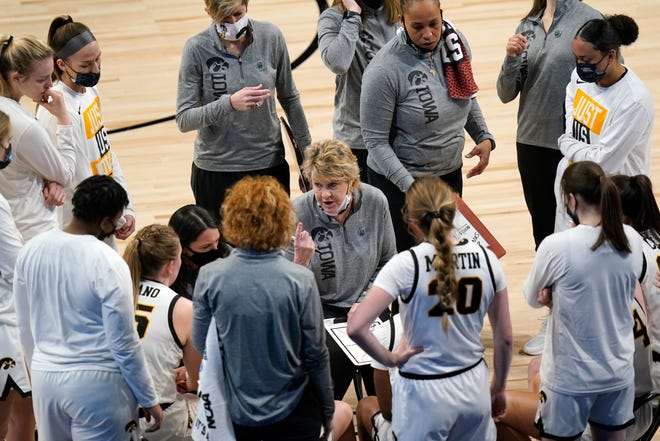 Iowa head coach Lisa Bluder talks to her team during a timeout in the first half of a college basketball game against Central Michigan in the first round of the women's NCAA tournament at the Alamodome, Sunday, March 21, 2021, in San Antonio.