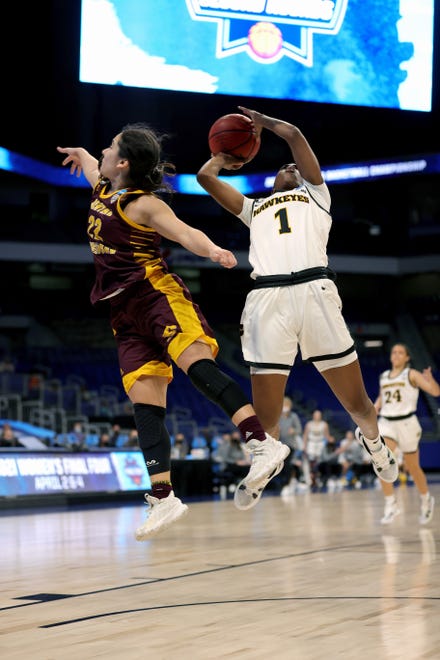 SAN ANTONIO, TEXAS - MARCH 21: Tomi Taiwo #1 of the Iowa Hawkeyes grabs a rebound ahead of Kalle Martinez #22 of the Central Michigan Chippewas during the first half in the first round game of the 2021 NCAA Women's Basketball Tournament at the Alamodome on March 21, 2021 in San Antonio, Texas. (Photo by Carmen Mandato/Getty Images)