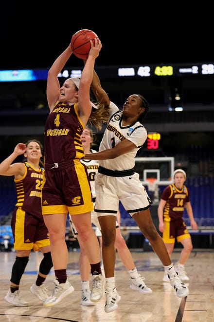 SAN ANTONIO, TEXAS - MARCH 21: Maddy Watters #4 of the Central Michigan Chippewas grabs a rebound ahead of Tomi Taiwo #1 of the Iowa Hawkeyes during the first half in the first round game of the 2021 NCAA Women's Basketball Tournament at the Alamodome on March 21, 2021 in San Antonio, Texas. (Photo by Carmen Mandato/Getty Images)