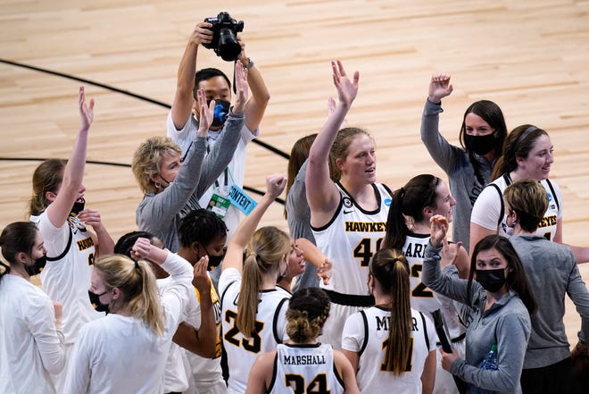 Iowa players and coaches celebrate after a college basketball game against Central Michigan in the first round of the women's NCAA tournament at the Alamodome, Sunday, March 21, 2021, in San Antonio. Iowa won 87-72.