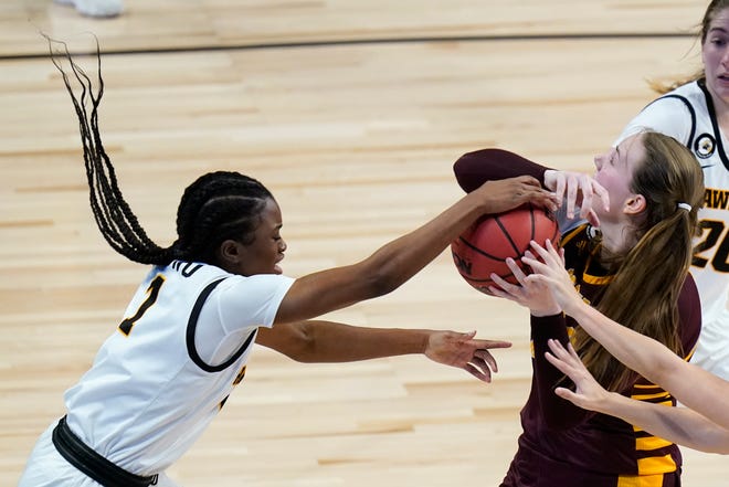 Iowa guard Tomi Taiwo, left, tries to steal the ball from Central Michigan forward Kyra Bussell during the first half of a college basketball game in the first round of the women's NCAA tournament at the Alamodome, Sunday, March 21, 2021, in San Antonio.