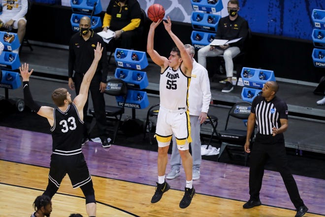 Mar 20, 2021; Indianapolis, IN, USA; Iowa Hawkeyes center Luka Garza (55) makes a three point shot over Grand Canyon Antelopes center Asbj¿rn Midtgaard (33) during the first round of the 2021 NCAA Tournament at Indiana Farmers Coliseum.