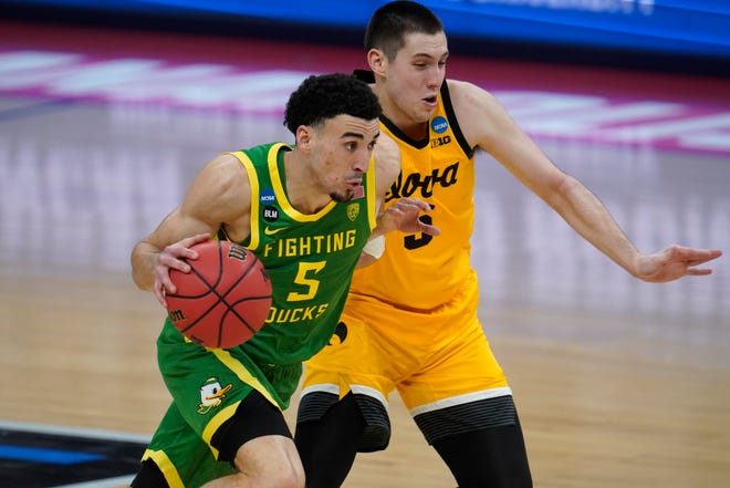 Oregon guard Chris Duarte (5) drives on Iowa guard CJ Fredrick during the second half of a men's college basketball game in the second round of the NCAA tournament at Bankers Life Fieldhouse in Indianapolis, Monday, March 22, 2021.