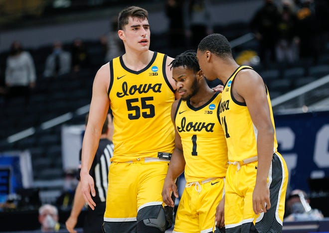 INDIANAPOLIS, INDIANA - MARCH 22: Luka Garza #55, Joe Toussaint #1, and Tony Perkins #11 of the Iowa Hawkeyes react during the game against the Oregon Ducks in the second round of the 2021 NCAA Men's Basketball Tournament at Bankers Life Fieldhouse on March 22, 2021 in Indianapolis, Indiana.
