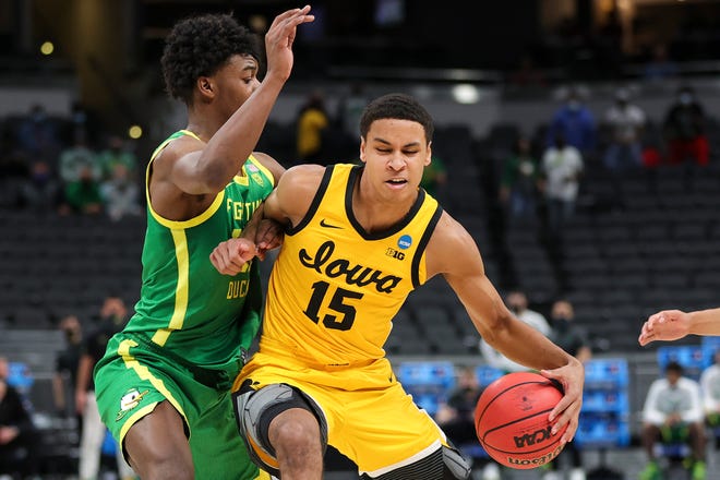 INDIANAPOLIS, INDIANA - MARCH 22: Keegan Murray #15 of the Iowa Hawkeyes handles the ball defended by Eric Williams Jr. #50 of the Oregon Ducks in the second round game of the 2021 NCAA Men's Basketball Tournament at Bankers Life Fieldhouse on March 22, 2021 in Indianapolis, Indiana.