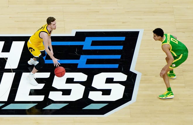 Mar 22, 2021; Indianapolis, Indiana, USA; Iowa Hawkeyes guard Jordan Bohannon (3) dribbles the ball as Oregon Ducks guard Will Richardson (0) defends during the first half in the second round of the 2021 NCAA Tournament at Bankers Life Fieldhouse.