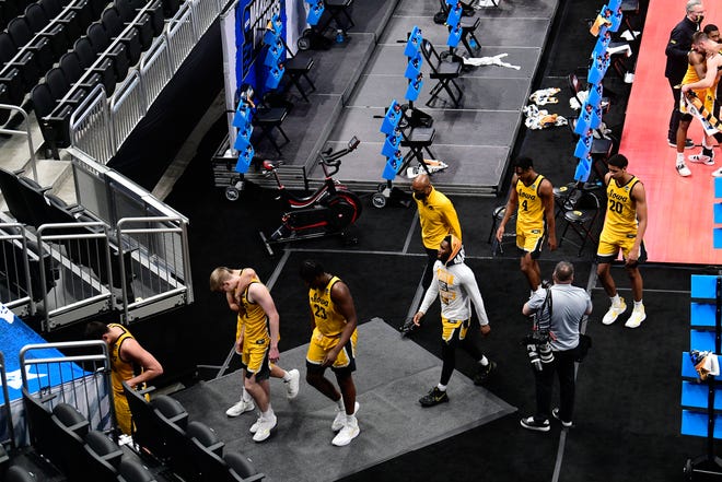Iowa Hawkeyes players walk off the court following their 95-80 loss against the Oregon Ducks during the second round of the 2021 NCAA Tournament on Monday, March 22, 2021, at Bankers Life Fieldhouse in Indianapolis, Ind.