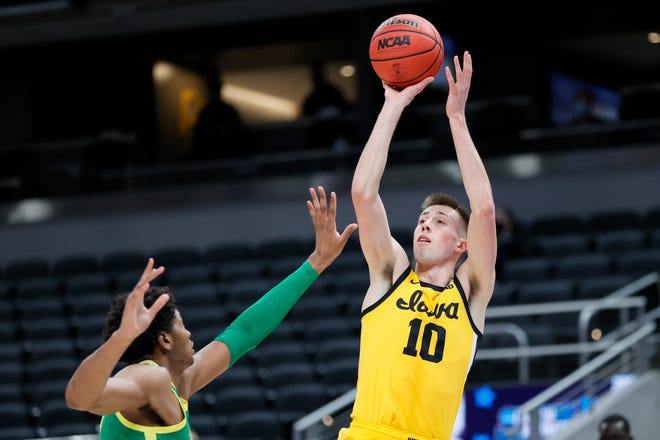 Iowa's Joe Wieskamp (10) shoots over Oregon's Chandler Lawson in the second round game of the 2021 NCAA Men's Basketball Tournament at Bankers Life Fieldhouse on March 22, 2021 in Indianapolis, Indiana.