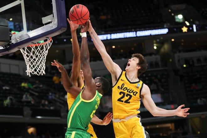 INDIANAPOLIS, INDIANA - MARCH 22: Patrick McCaffery #22 of the Iowa Hawkeyes blocks a shot by Eugene Omoruyi #2 of the Oregon Ducks in the second round game of the 2021 NCAA Men's Basketball Tournament at Bankers Life Fieldhouse on March 22, 2021 in Indianapolis, Indiana.