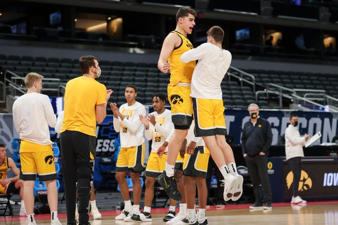 Iowa center Luka Garza celebrates with Austin Ash during player introductions ahead of the game against the Oregon Ducks in the second round of the 2021 NCAA Men's Basketball Tournament at Bankers Life Fieldhouse on March 22, 2021 in Indianapolis, Indiana.