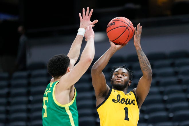 Iowa's Joe Toussaint (1) shoots a basket as Oregon's Chris Duarte (5) defends in the second round game of the 2021 NCAA Men's Basketball Tournament at Bankers Life Fieldhouse on March 22, 2021 in Indianapolis, Indiana.