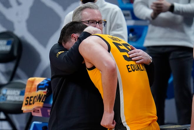 Iowa head coach Fran McCaffery hugs Luka Garza (55) during the second half of a men's college basketball game against Oregon in the second round of the NCAA tournament at Bankers Life Fieldhouse in Indianapolis, Monday, March 22, 2021.