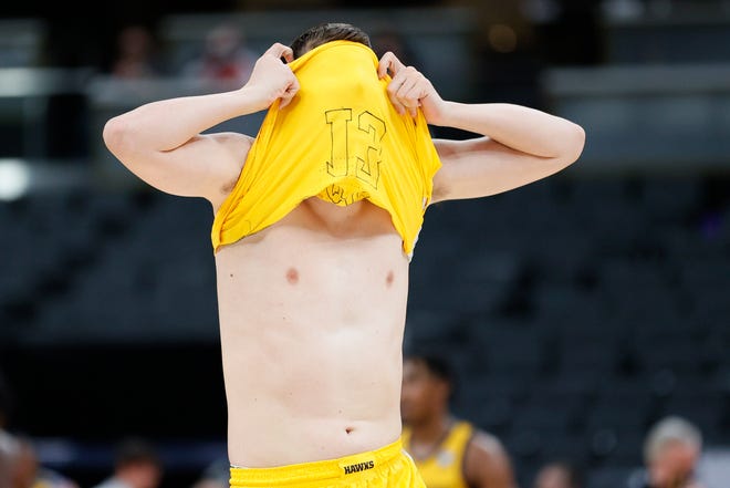 INDIANAPOLIS, INDIANA - MARCH 22: Austin Ash #13 of the Iowa Hawkeyes reacts to losing to the Oregon Ducks in the second round game of the 2021 NCAA Men's Basketball Tournament at Bankers Life Fieldhouse on March 22, 2021 in Indianapolis, Indiana.