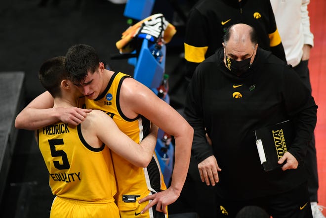Iowa Hawkeyes center Luka Garza (55) hugs guard CJ Fredrick (5) after their 95-80 loss against the Oregon Ducks during the second round of the 2021 NCAA Tournament on Monday, March 22, 2021, at Bankers Life Fieldhouse in Indianapolis, Ind.