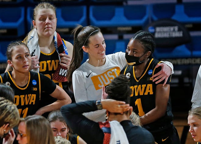 Iowa guard Caitlin Clark hugs guard Tomi Taiwo (1) during the final minute of the team's college basketball game against Kentucky in the second round of the NCAA women's tournament at Greehey Arena in San Antonio, Tuesday, March 23, 2021. Iowa won 86-72.