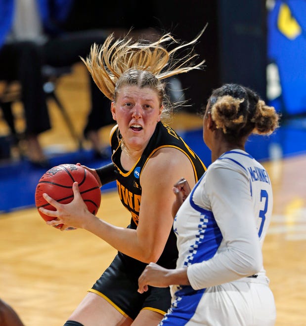 Iowa forward Monika Czinano (25) prepares to drive by Kentucky forward Keke McKinney (3) during the first half of a college basketball game in the second round of the women's NCAA tournament at the Greehey Arena in San Antonio, Texas, Tuesday, March 23, 2021.